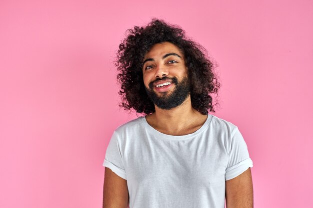 Pleasant indian arabian male in shirt looking at camera, has friendly look