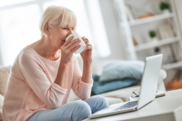 Pleasant memories. Beautiful senior woman drinking coffee