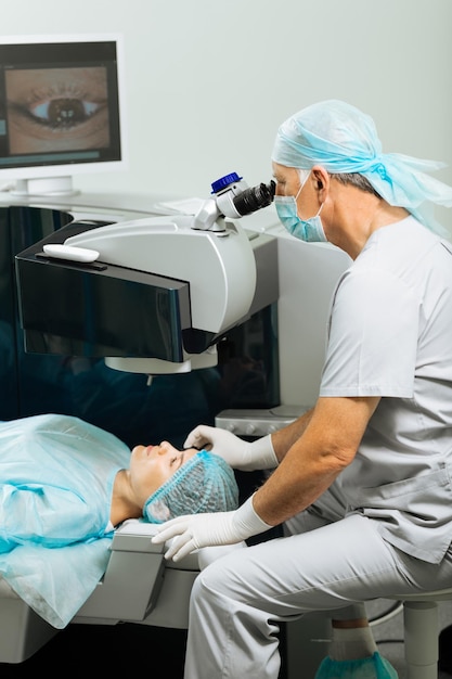 Pleasant nice woman visiting a doctor while having a vision control test