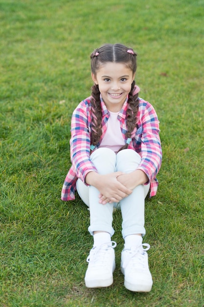 pleasant walk in park smile and joy fashionable hairstyle for kids girl small kid with fashionable braids hairstyle charming smile fashion trend salon and hair care girl smile face outdoors