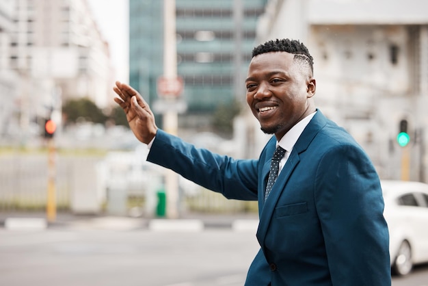 Please get me out of here. Shot of a young businessman hailing a cab.