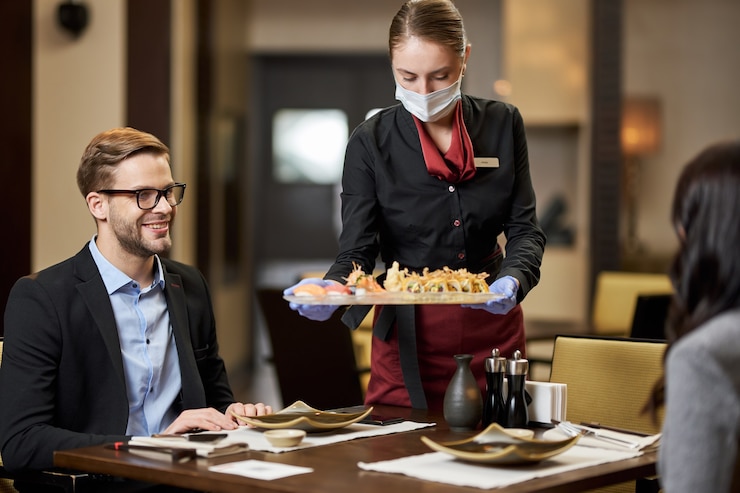 Photo pleased gentleman and his date being served sushi at restaurant