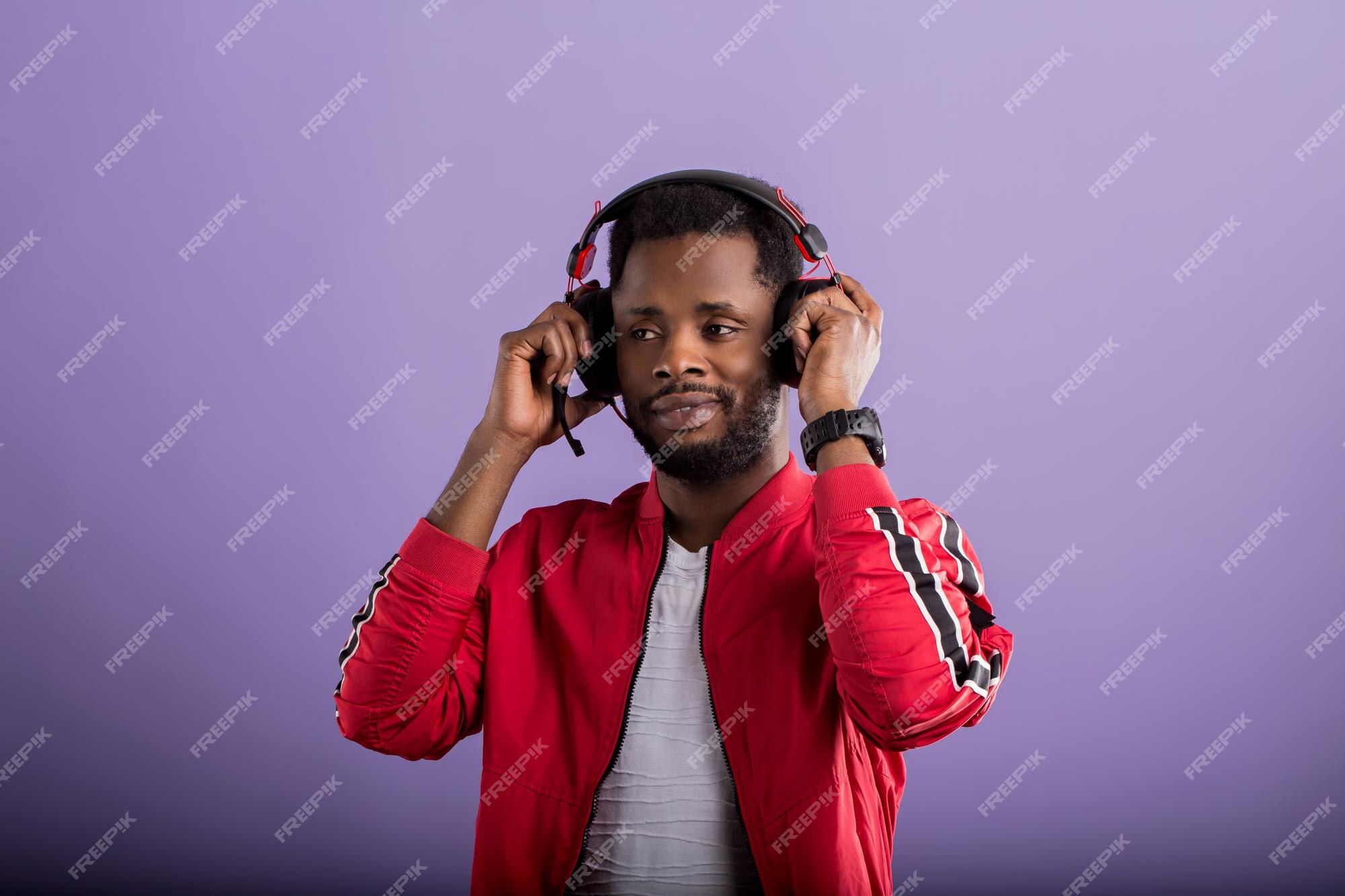 Positive man listening music with headphones, dancing on dark neon  background. Stylish student guy enjoying life, active energy, inspired  dance concept - a Royalty Free Stock Photo from Photocase