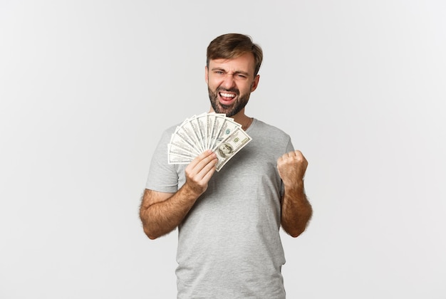 Pleased smiling man with beard, wearing gray t-shirt