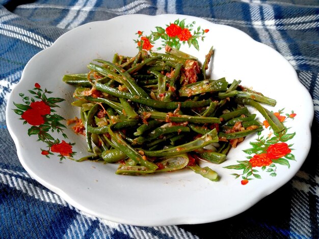 Plecing Kacang Panjang Khas Bali or long beans with chili sauce Indonesian culinary food