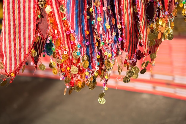 Plenty of fake gold coins are on the scarf edges