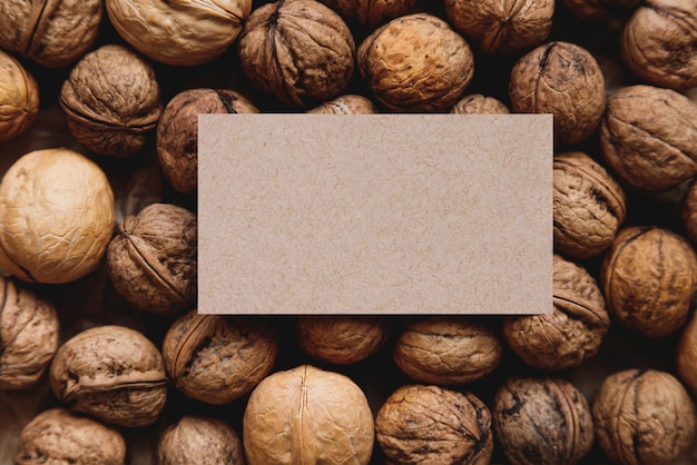 Plenty walnuts with shells with business card templete on it mock up