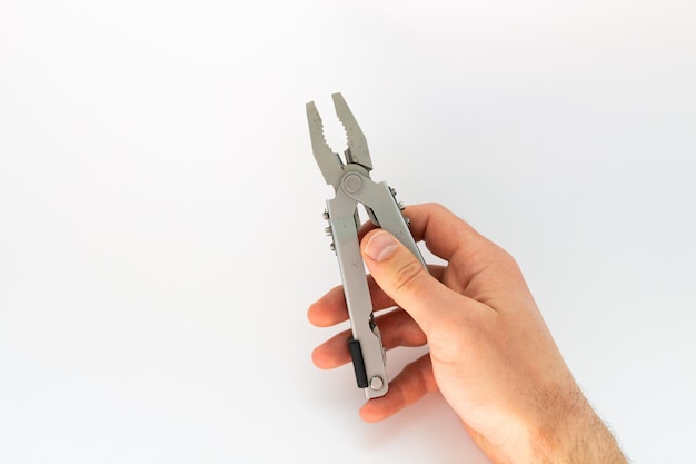 Pliers in hand on a white background