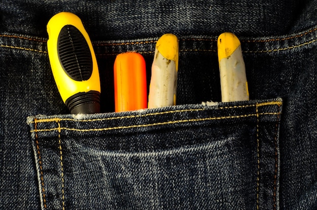 Pliers and screwdrivers in a pocket of the jeans