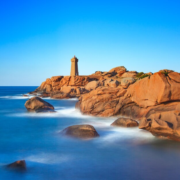 Ploumanach lighthouse sunset in pink granite coast Brittany France