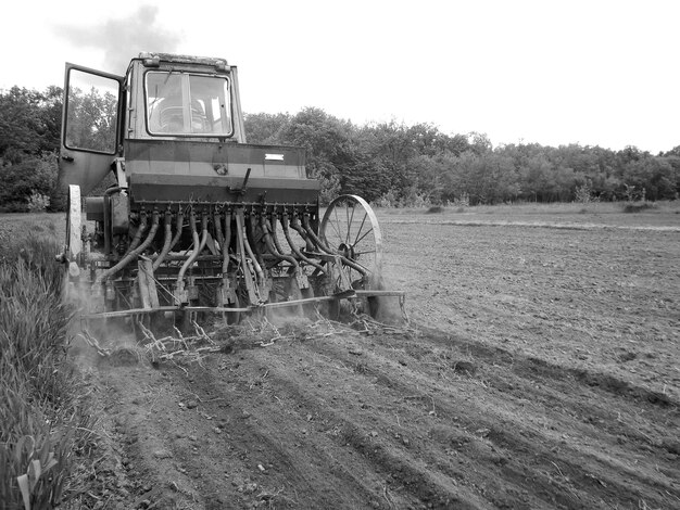 Plowed field by tractor in black soil on open countryside nature