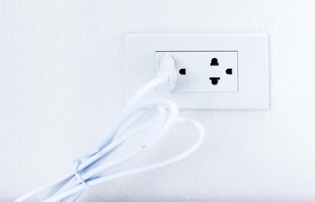 Plug power socket on the white wall