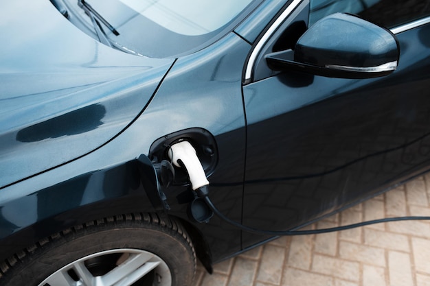 Plugin hybrid car charge at special station Closeup top view of plug