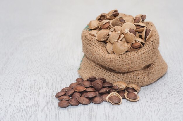 Plukenetia volubilis dry with Seed Sacha-Inchi Peanut on pile in organic jute bag