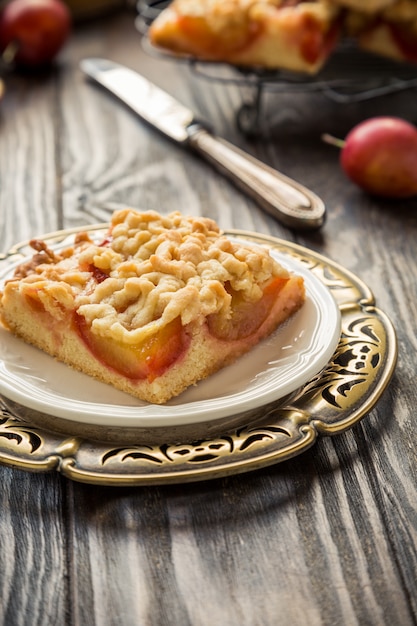 Plum crumb cake pie cut into squares. Healthy autumn food concept.