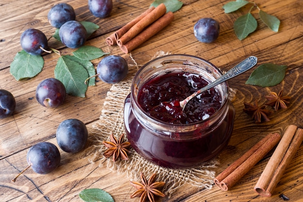 Plum jam in a glass jar. Fresh plum fruit 