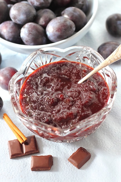 Plum jam with chocolate and cinnamon in a crystal bowl