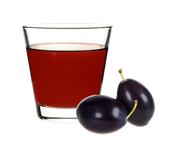 Plum juice in a glass with plums on a white background