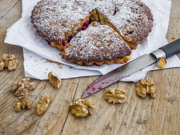 Photo plum pie on a dark surface