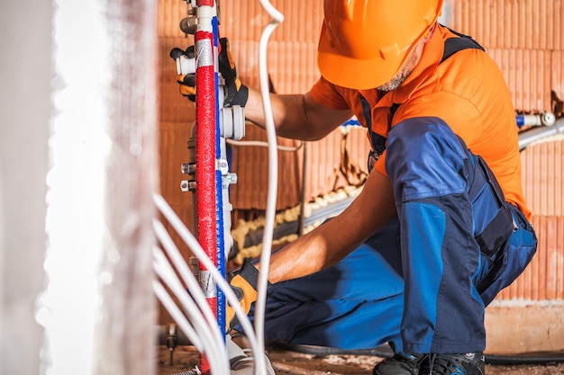 Photo plumber installing bathroom water supply