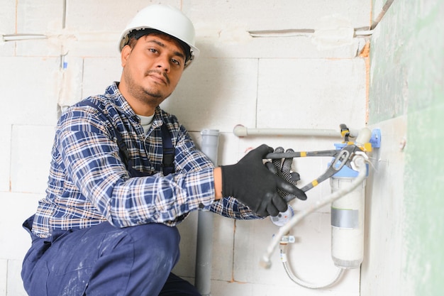 plumber installing water equipment meter filter and pressure reducer