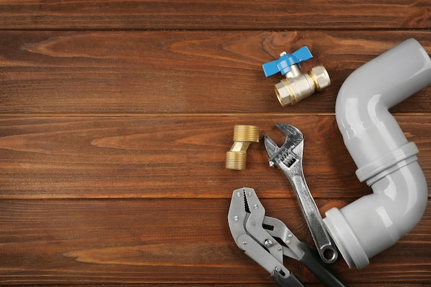 Plumber tools on a wooden background