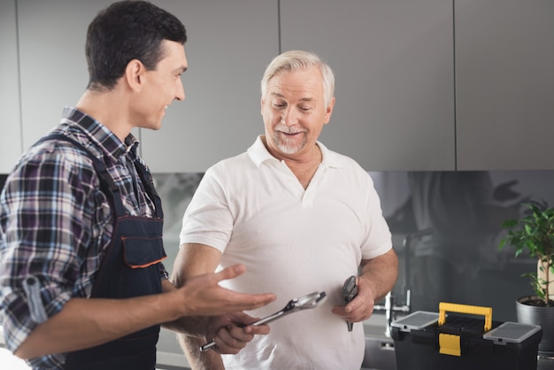 Plumbers are holds a power key in hands 