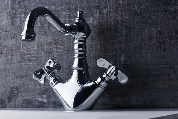 Plumbing. The interior of the bathroom. Faucet sink on black and white background.