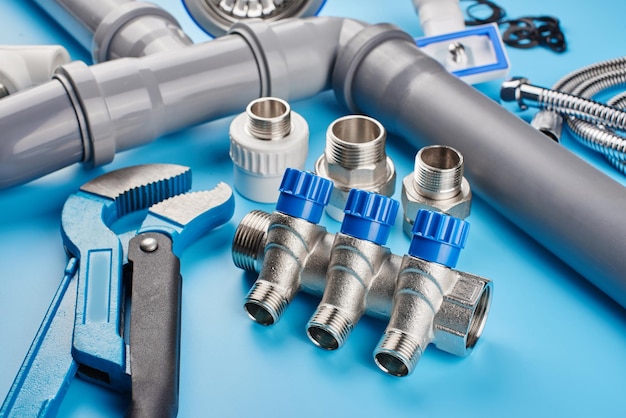 Plumbing tools and equipment on blue background