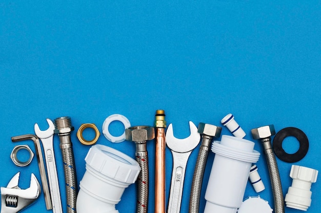 Photo plumbing tools and equipment overhead view on a blue background