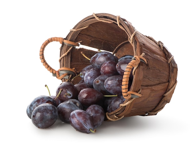 Plums in a basket isolated on white