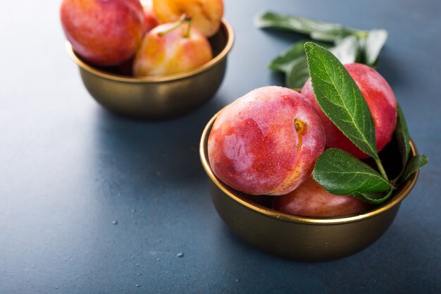 Plums in bronze bowl