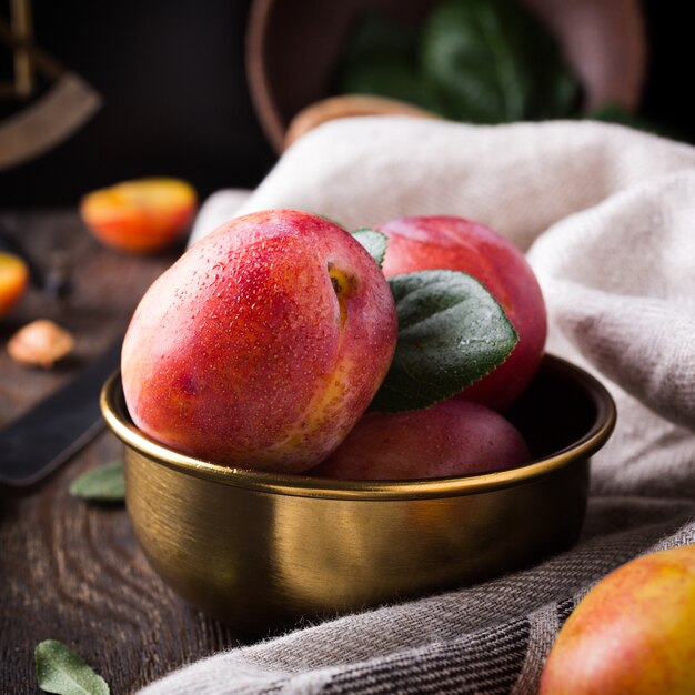 Plums in bronze bowl