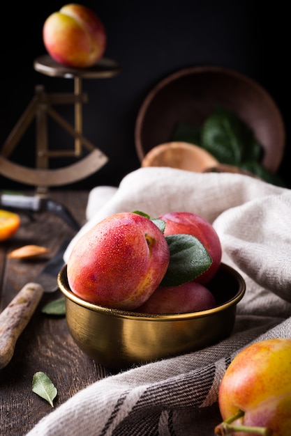 Plums in bronze bowl