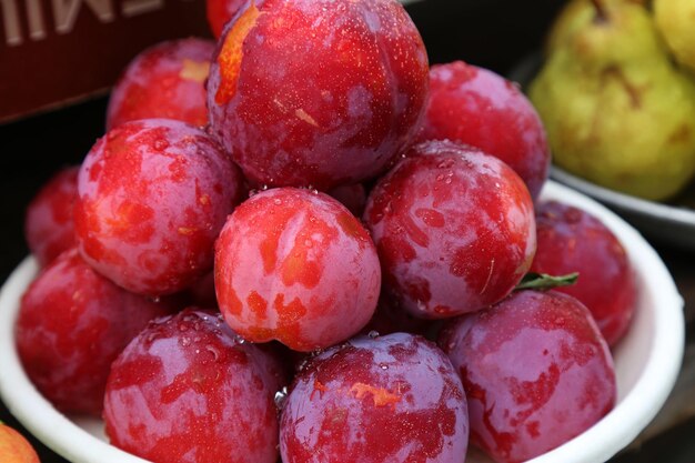 Plums close up on the local farm market eco juicy fruits Shopping organic products Healthy grocery Summer autumn season market High quality photo