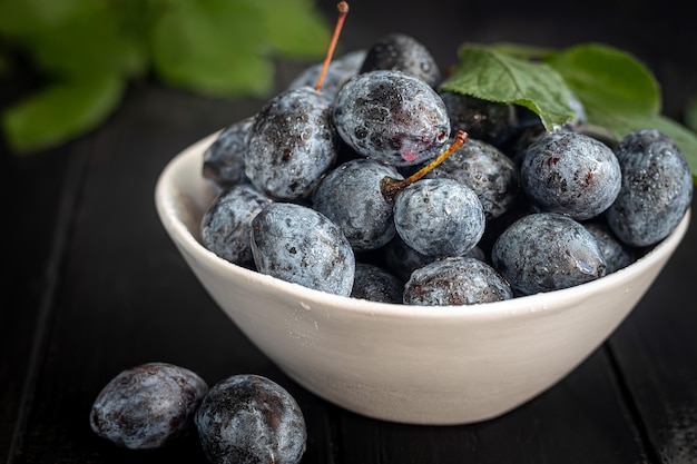 Plums on a dark background. Harvesting the autumn harvest. Making jam and sauce. Still life.