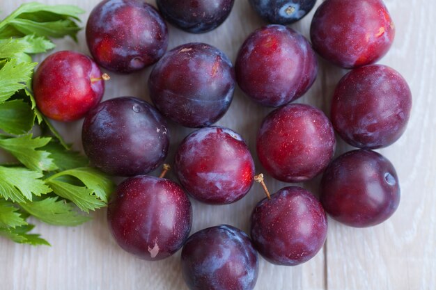 plums on a dark wood background.