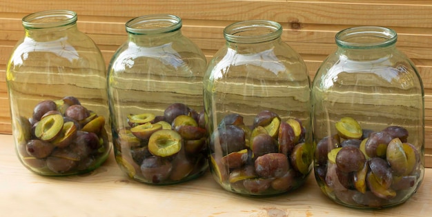 Plums placed in jars Plum compote in the cooking process