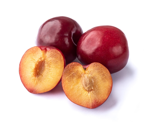 Photo plums with half fruit isolated over white background