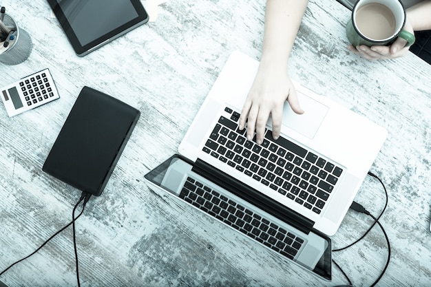 A plus size adult woman working in the home office.
