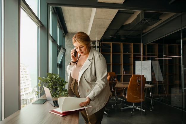 Photo plus-size business woman working in a professional office