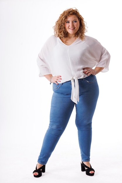 Plus size fashion model fat woman in denim clothes and white shirt on white background overweight female body