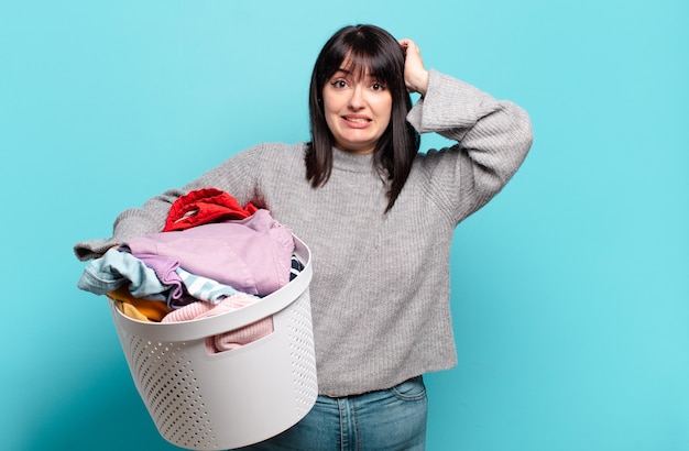 Plus size pretty woman feeling stressed, worried, anxious or scared, with hands on head, panicking at mistake