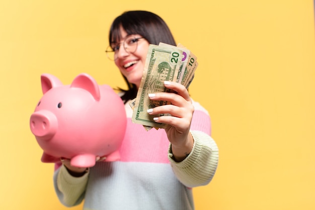 Plus size pretty woman with a piggy bank. savings concept