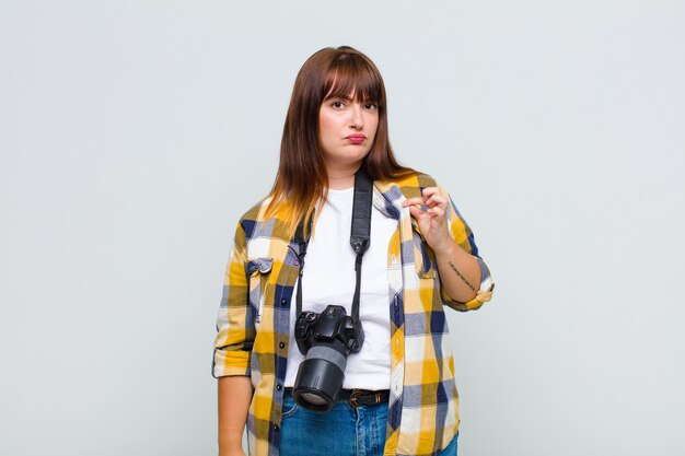 Plus size woman looking arrogant, successful, positive and proud, pointing to self