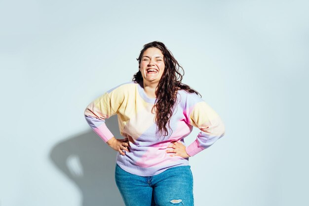 Plus size woman model posing in studio and having fun