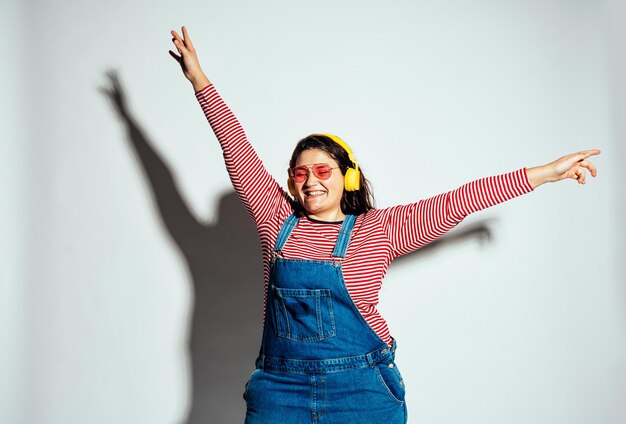 Plus size woman model posing in studio and having fun