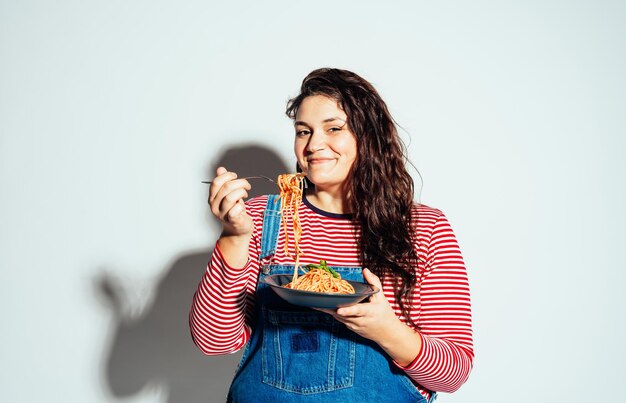 Plus size woman model posing in studio and having fun