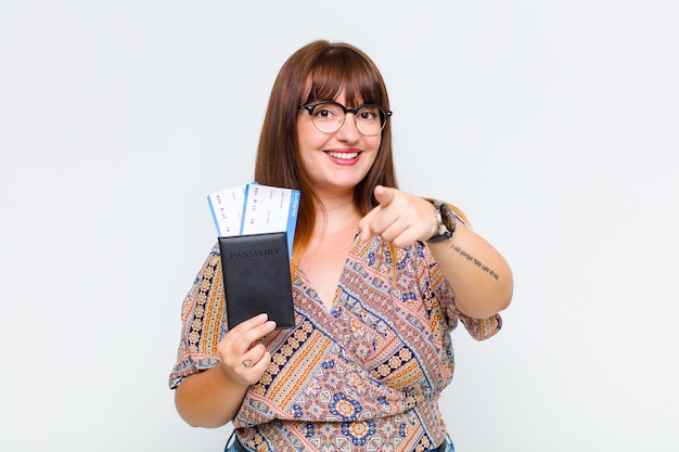 Plus size woman pointing with a satisfied, confident, friendly smile, choosing you