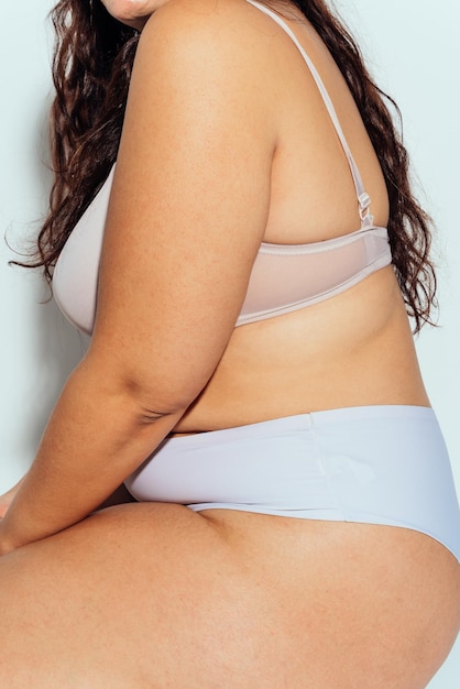 Plus size woman posing in studio in lingerie